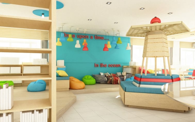 Bright kids’ learning space and library interior with colorful bean bags, reading nooks, interactive play area, bookshelves, and vibrant blue accent wall with playful lighting