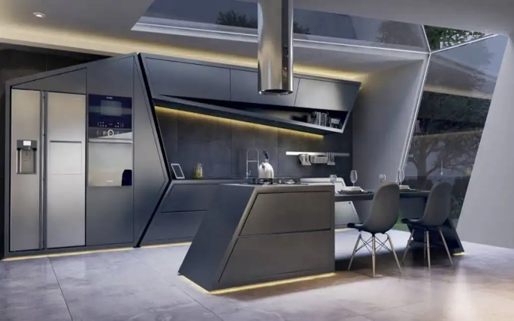 Futuristic ultra-modern kitchen interior featuring asymmetrical dark grey geometric cabinets, a matching angular island with an attached dining extension, stainless steel appliances, and a prominent cylindrical ceiling hood