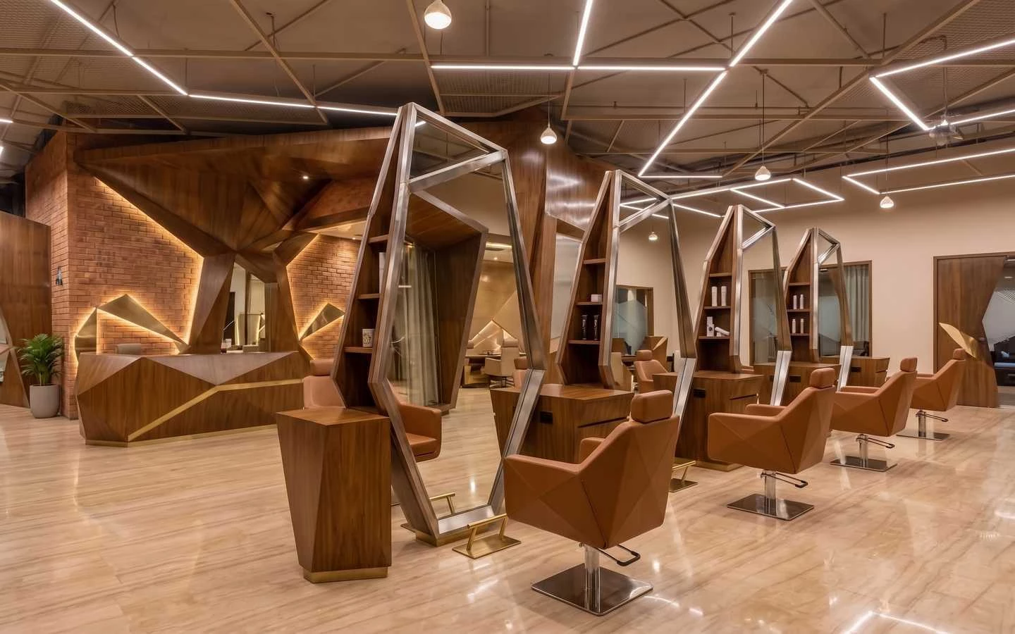 Modern hair salon interior featuring geometric wooden styling stations, angular mirrors, tan leather chairs, and industrial linear ceiling lighting