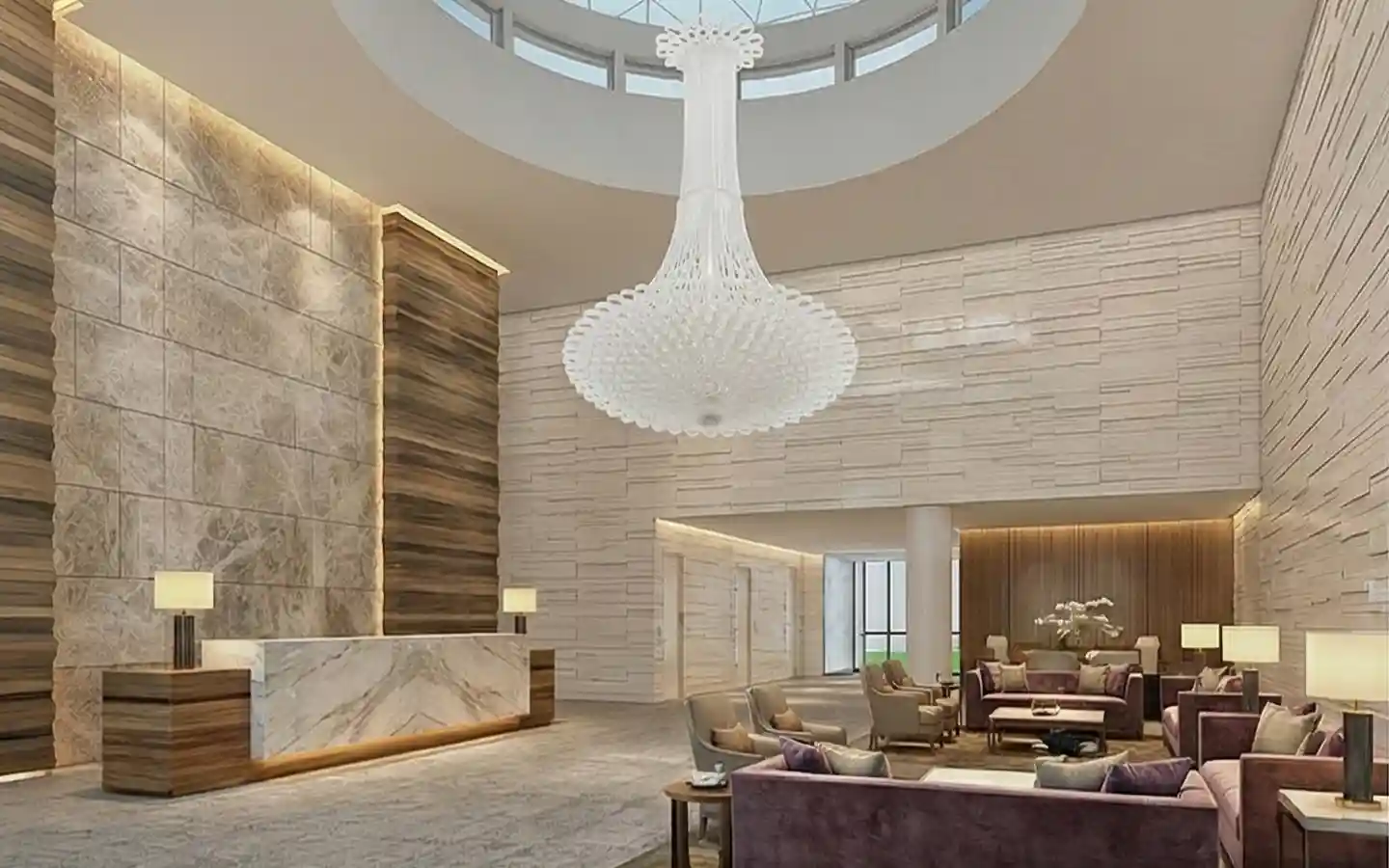 Grand hotel reception area featuring a marble front desk, large white decorative chandelier, skylight, and stone textured wall panels