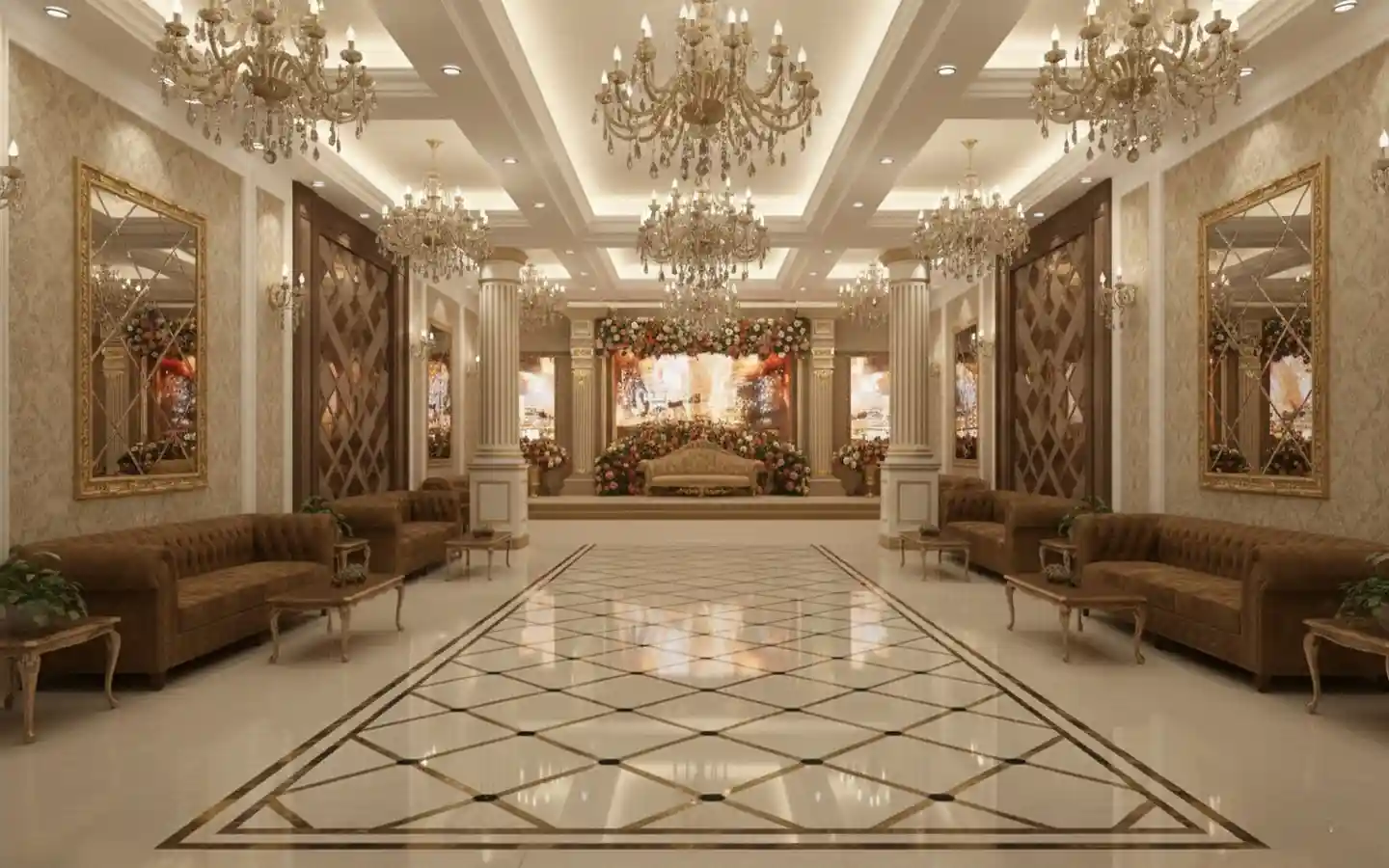 Grand wedding hall interior featuring luxurious crystal chandeliers, brown tufted sofas, and a floral decorated stage backdrop