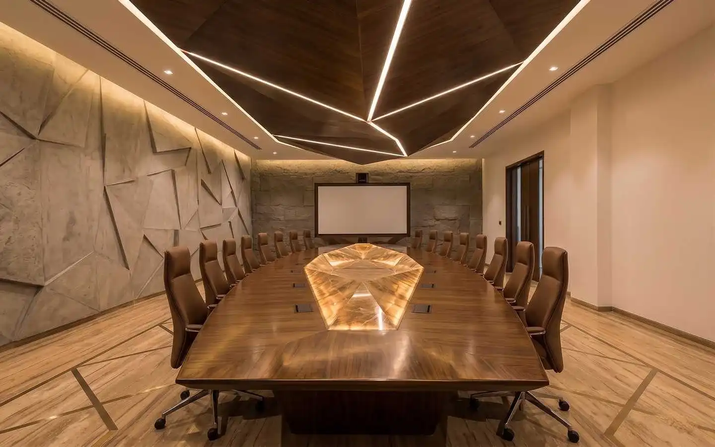 Luxury commercial boardroom featuring a geometric wood ceiling with linear lighting, a custom long conference table, and textured 3D wall panels