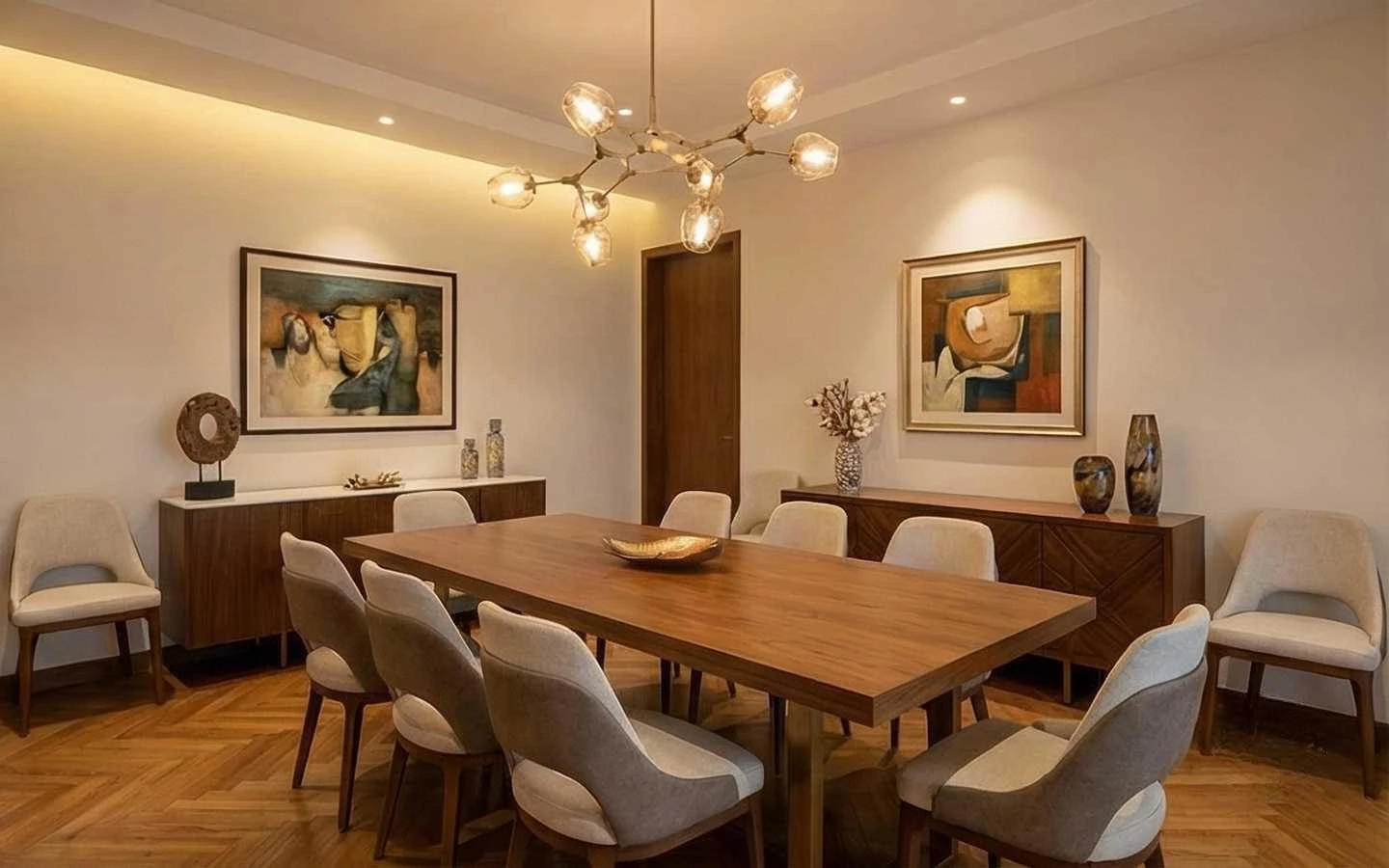 Luxury dining room interior design featuring a large wooden dining table, contemporary upholstered chairs, a modern glass globe chandelier, and oak chevron wood flooring