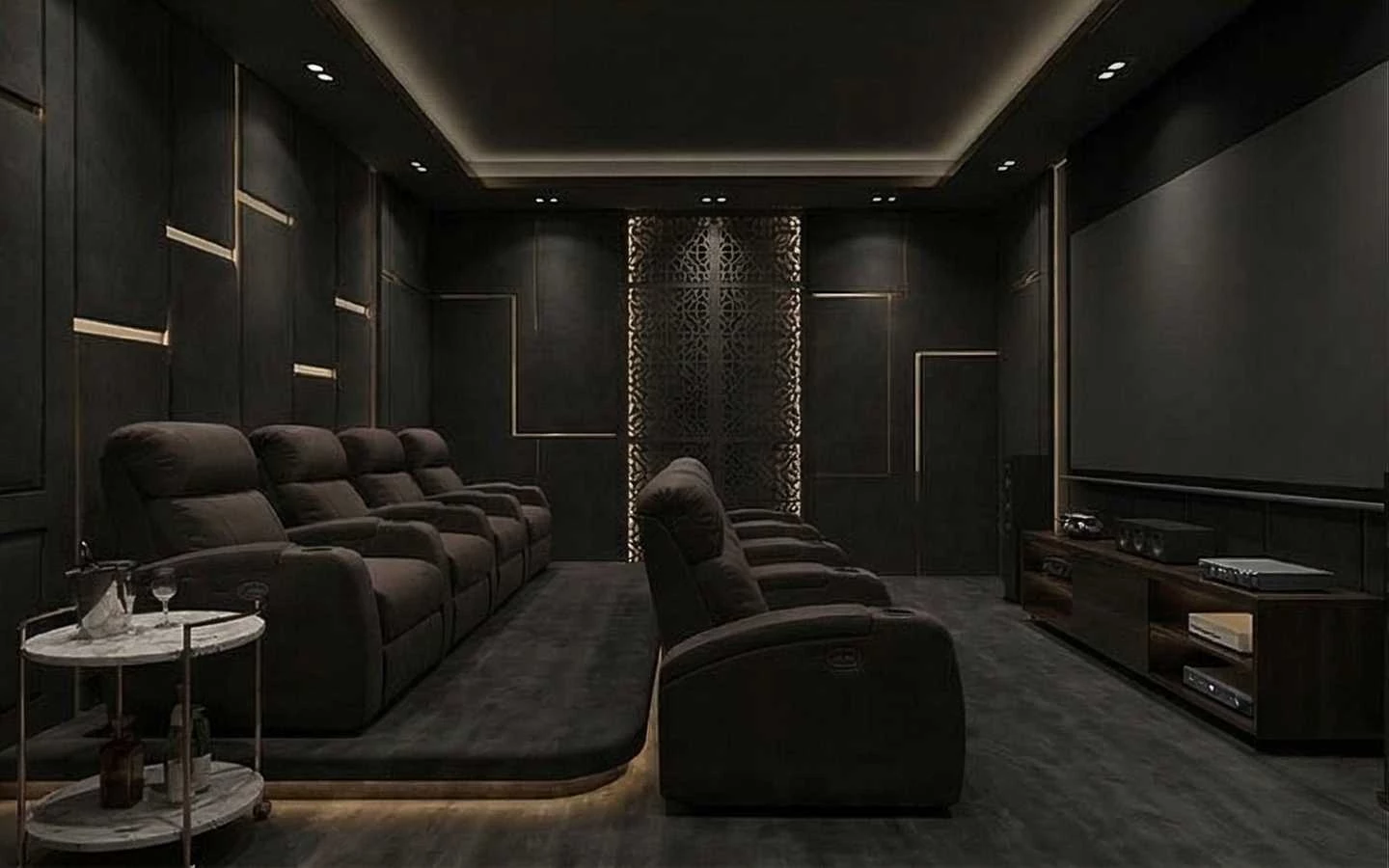 Modern luxury home theater room featuring dark charcoal acoustic wall panels with gold accents, tiered leather recliner seating, and a large projection screen
