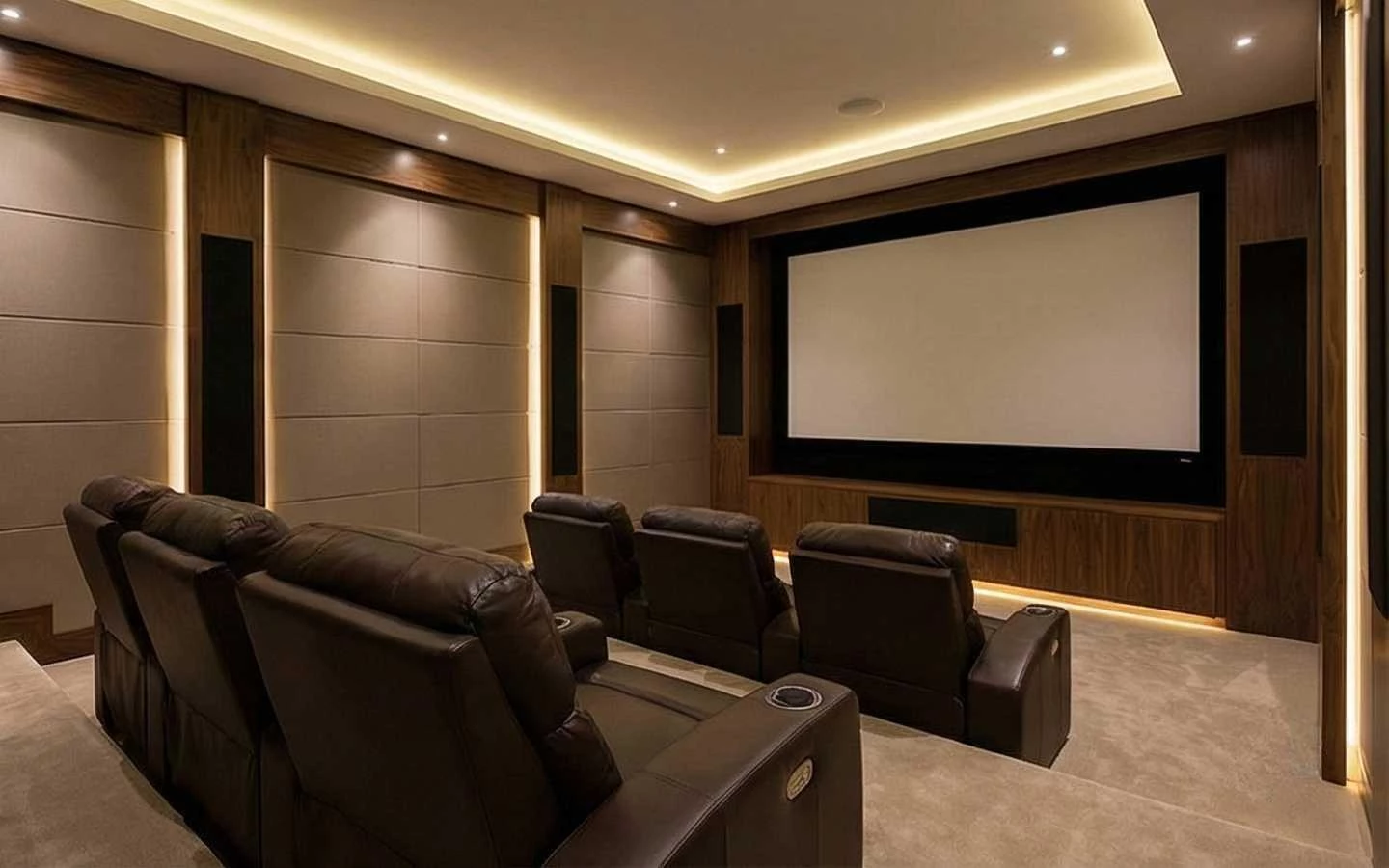 Luxury home cinema room featuring tiered brown leather recliner seating, a large projection screen, and integrated cove lighting with wood acoustic wall panels