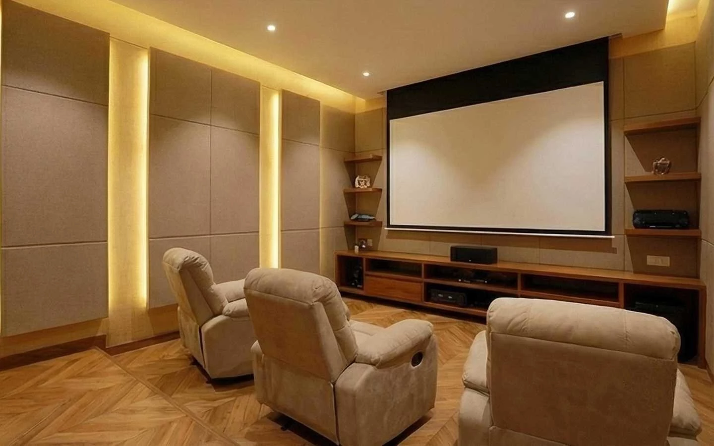 Modern home theater room featuring tan recliner seating, acoustic fabric wall panels with integrated LED strip lighting, a large projection screen, and chevron wood flooring