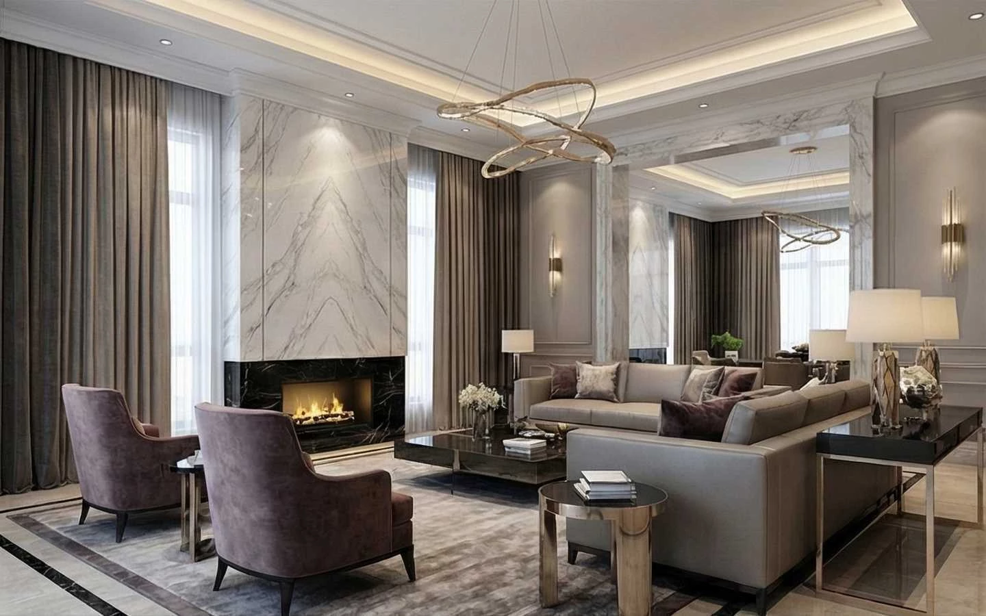 Luxury living room design featuring a floor-to-ceiling white marble fireplace, a modern gold loop chandelier, velvet armchairs, and a large grey sectional sofa