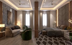 Modern luxury master bedroom featuring a grey upholstered bed, a separate sitting area with a curved sofa and green velvet armchair, and elegant tray ceiling lighting