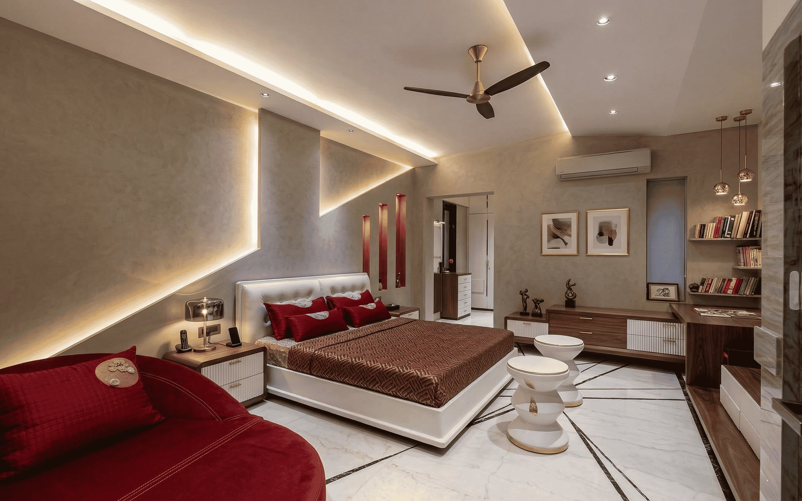 Modern luxury master bedroom featuring a king-size bed with red accents, custom geometric ambient wall lighting, white marble flooring, and a contemporary study nook