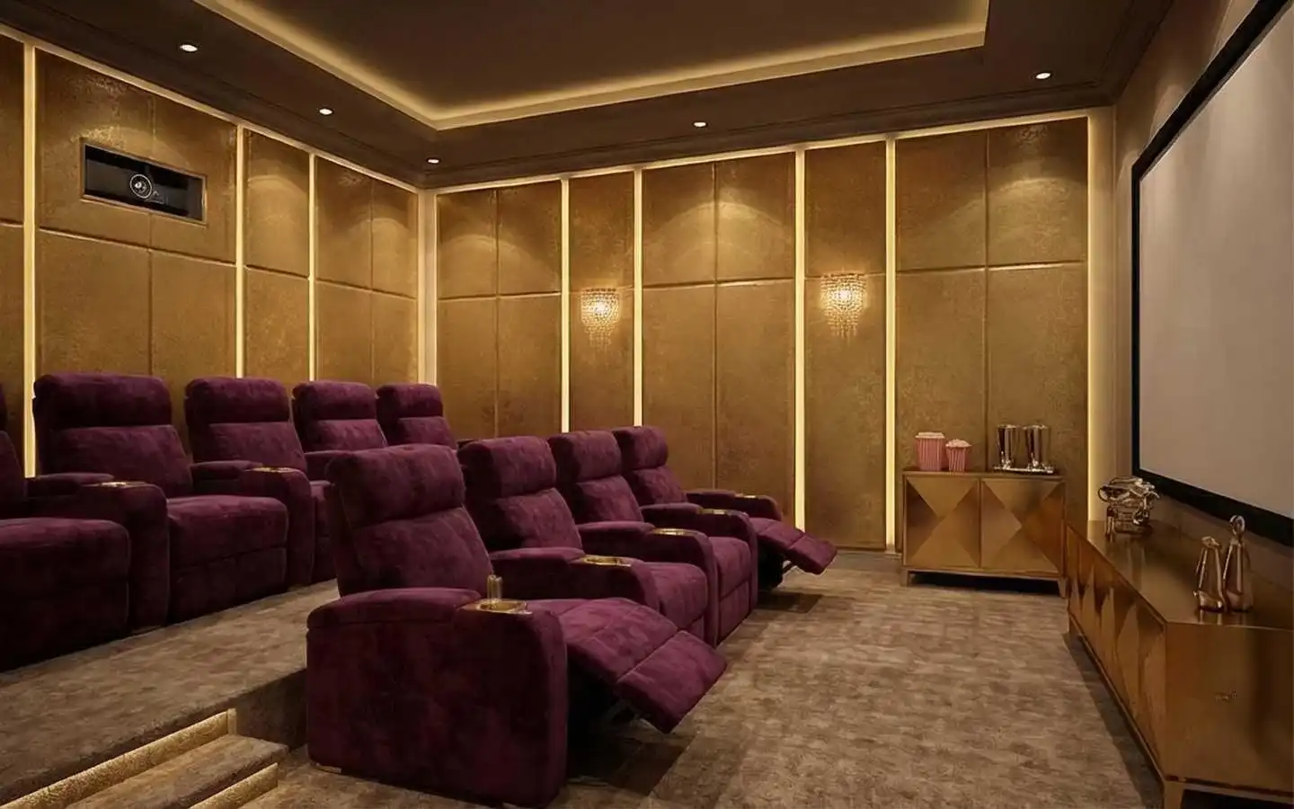Luxury residential home theater featuring tiered purple velvet recliner seating, gold textured wall panels with integrated LED lighting, crystal wall sconces, and a large projection screen