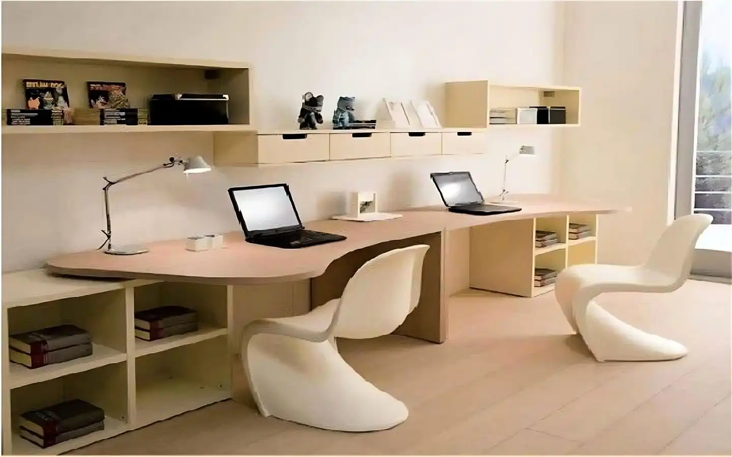Modern minimalist home office featuring a long light wood double desk, two white ergonomic S-chairs, and wall-mounted floating shelves
