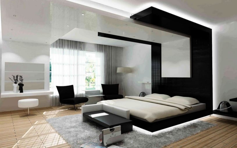 Ultra-modern master bedroom featuring a high-contrast black and white color palette, architectural cove lighting, a glossy floating ceiling feature, and minimalist furniture on light wood flooring