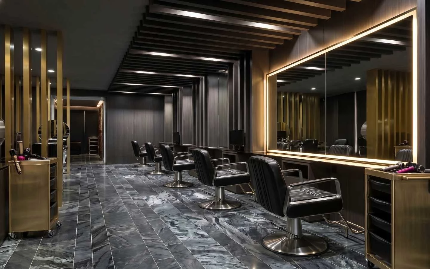 Upscale barber shop interior with black leather chairs, gold accents, marble flooring, and large backlit mirrors