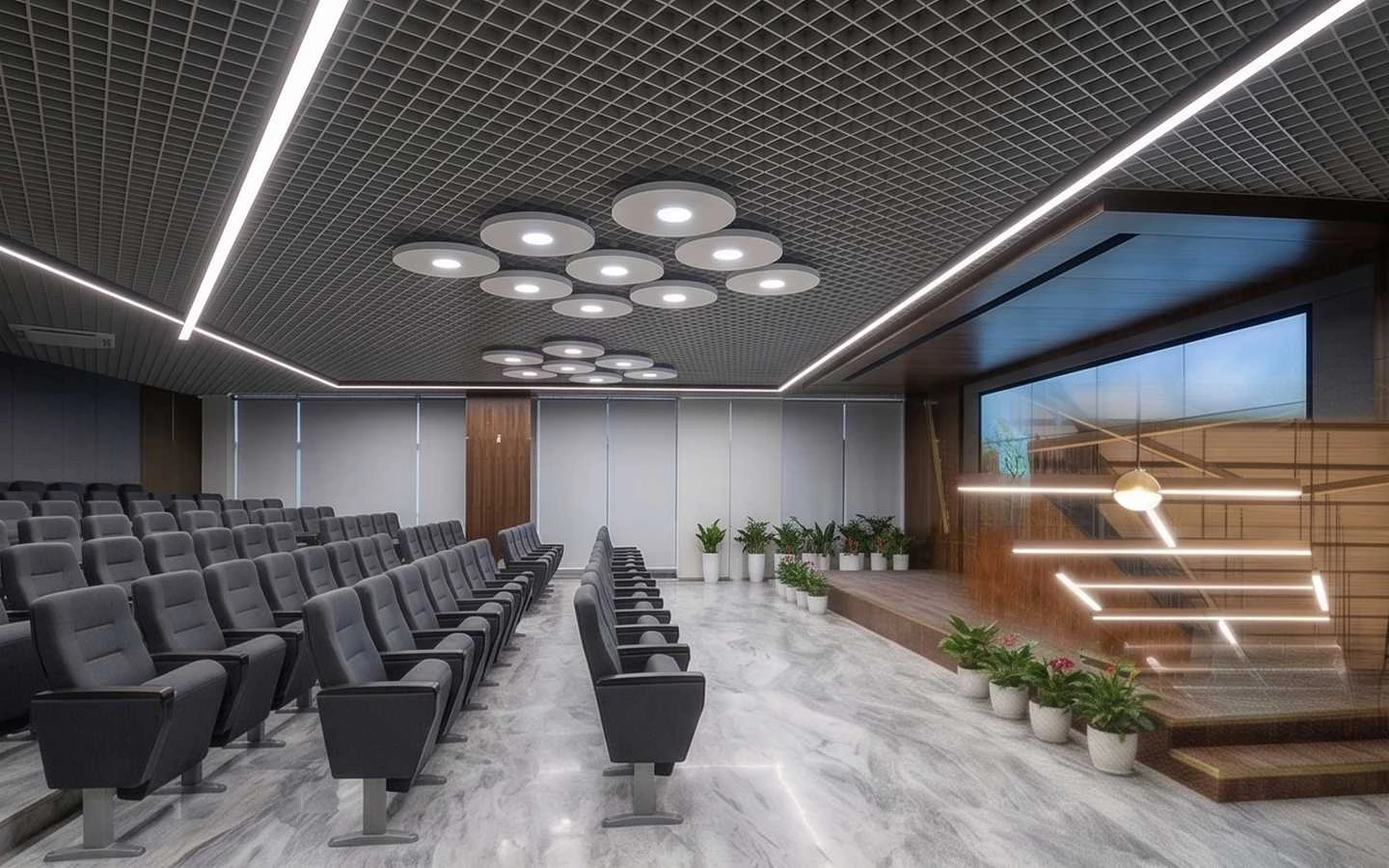 Modern corporate auditorium interior design with tiered grey seating, marble flooring, and decorative circular ceiling lights