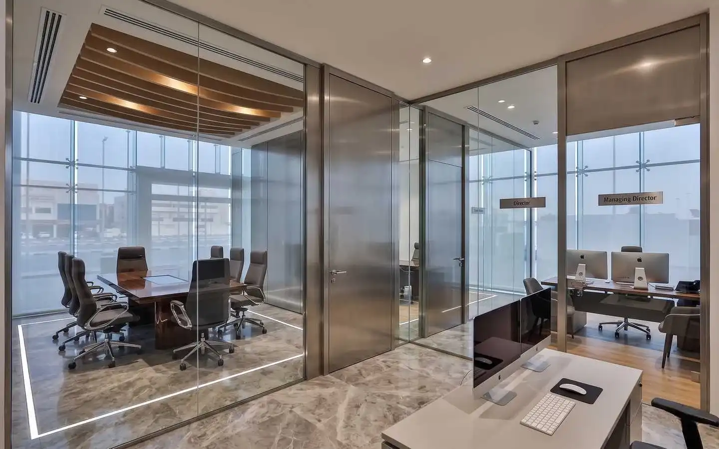 Luxury corporate office interior featuring sleek glass partitions, a modern conference room with wood slat ceilings, and private executive offices for Directors