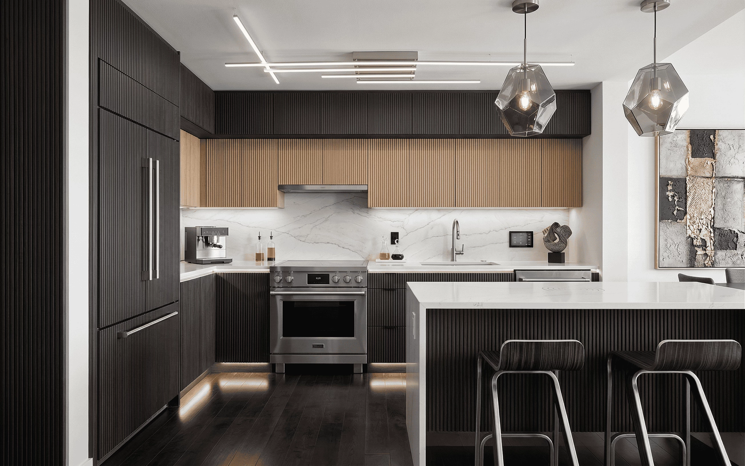 Modern luxury kitchen featuring dark fluted wood cabinetry, white marble countertops, and geometric pendant lighting over a kitchen island