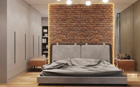 Modern home bedroom interior featuring a red exposed brick accent wall with warm backlight, grey upholstered bed, and minimalist wardrobes