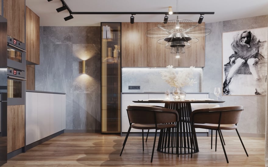 Modern industrial home kitchen featuring wood cabinets, grey stone-textured walls, a round black dining table with brown chairs, and a designer wire chandelier