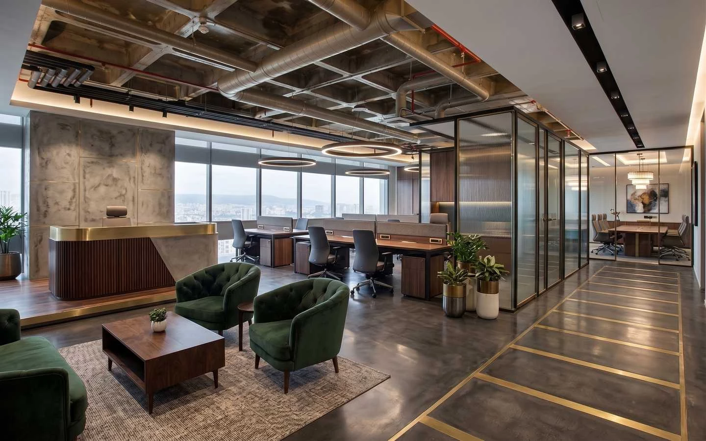 Modern industrial office interior featuring open workstations, green velvet lounge chairs, and exposed ceiling pipes