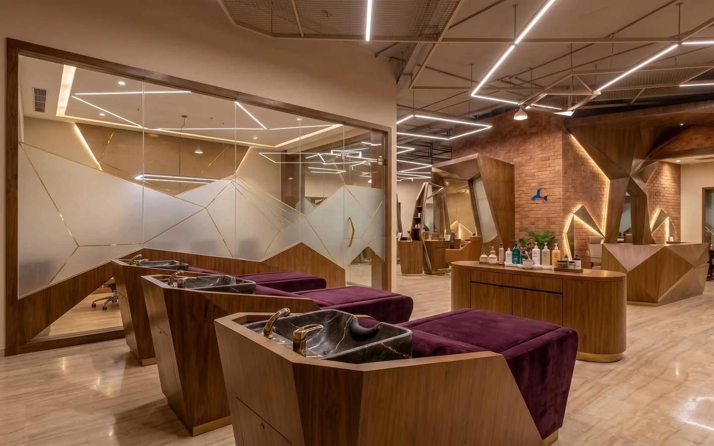 Modern industrial salon interior featuring velvet purple shampoo chairs, marble basins, geometric wood paneling, and exposed brick walls