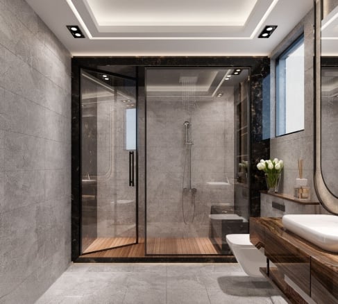 Modern luxury bathroom design featuring a glass-enclosed shower with wooden floor, grey stone wall tiles, and a floating dark wood vanity
