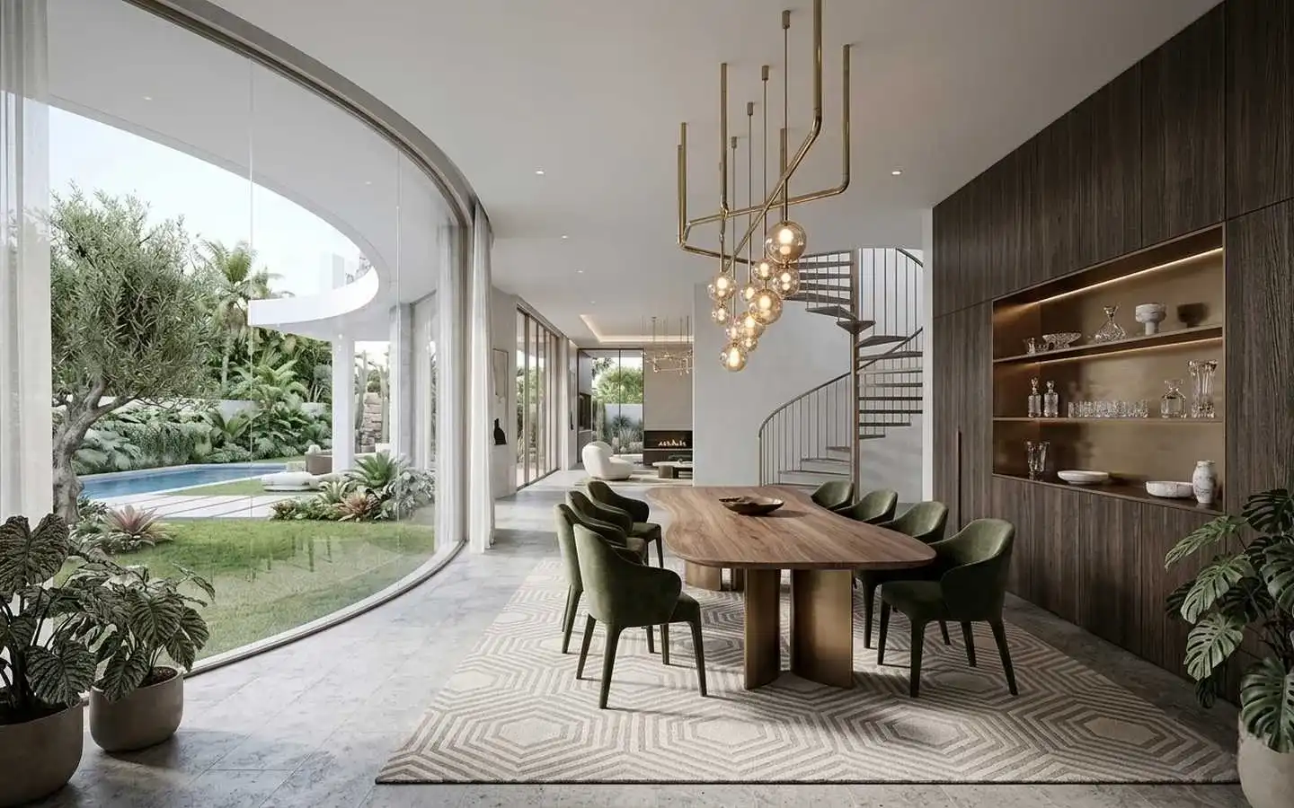 Upscale villa dining room with a curved floor-to-ceiling glass wall, organic wooden dining table, green velvet chairs, and a spiral staircase overlooking a private pool