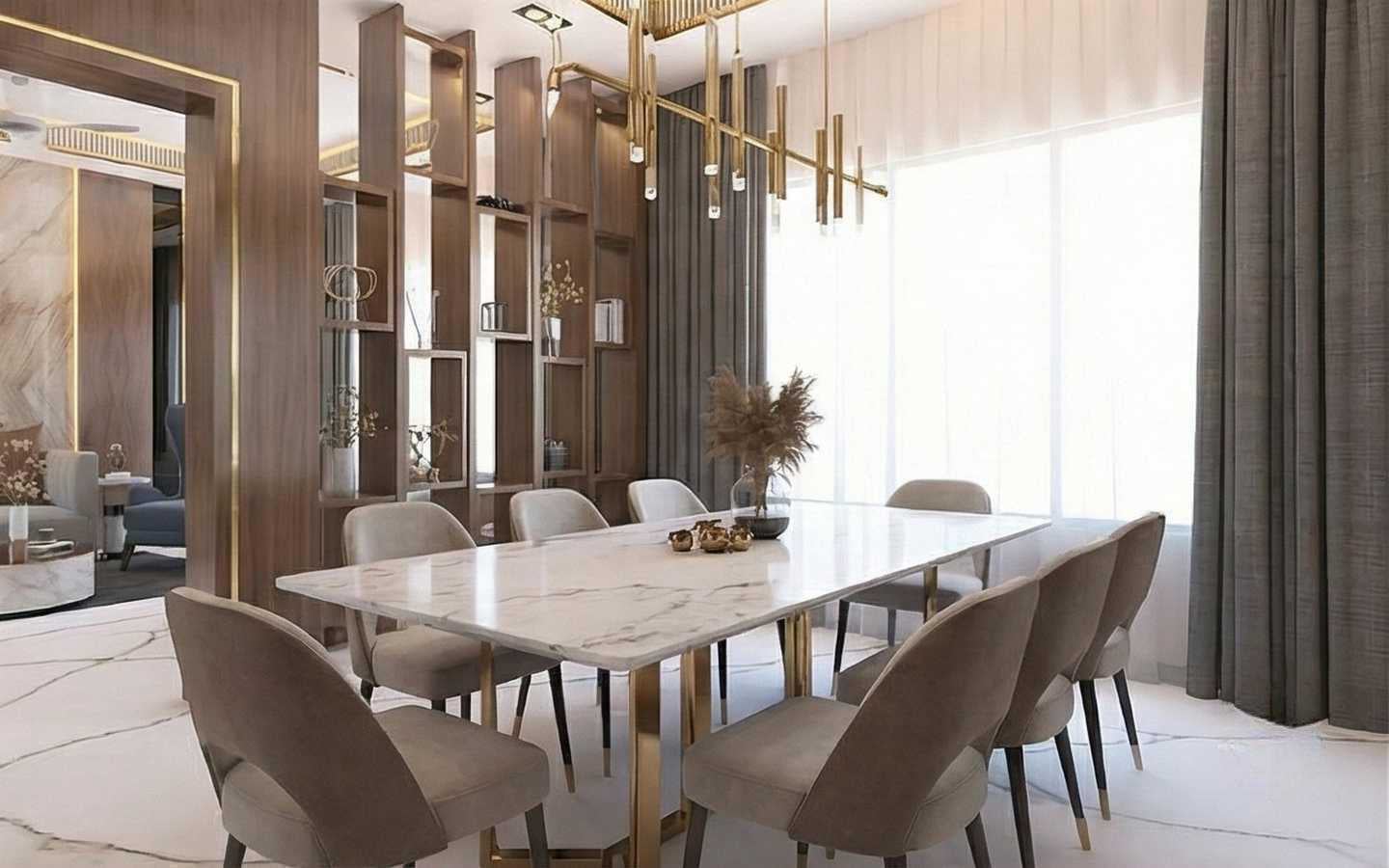 Luxury dining room featuring a white marble table with gold legs, velvet chairs, and a custom floor-to-ceiling wooden shelving unit acting as a room divider