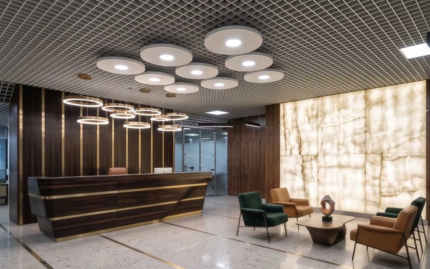 Modern office reception area featuring a dark wood desk, marble accent wall, and circular pendant lighting
