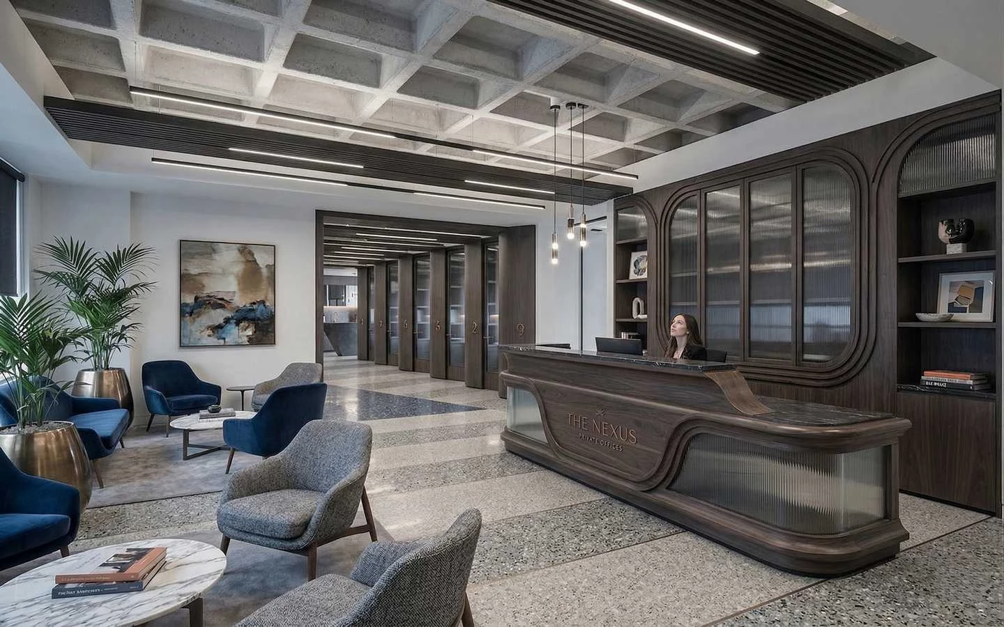 Modern luxury office reception area featuring a custom dark wood desk, marble flooring, and industrial waffle ceiling design