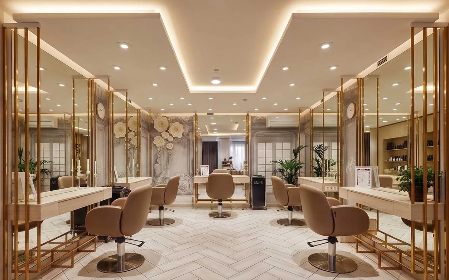 Modern luxury beauty salon interior with gold framed mirrors, tan leather styling chairs, and warm recessed ceiling lighting