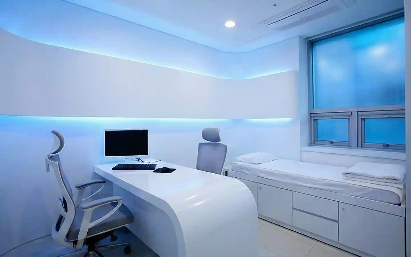 Futuristic medical clinic consultation room with a white curved desk, ergonomic office chairs, and blue ambient LED cove lighting