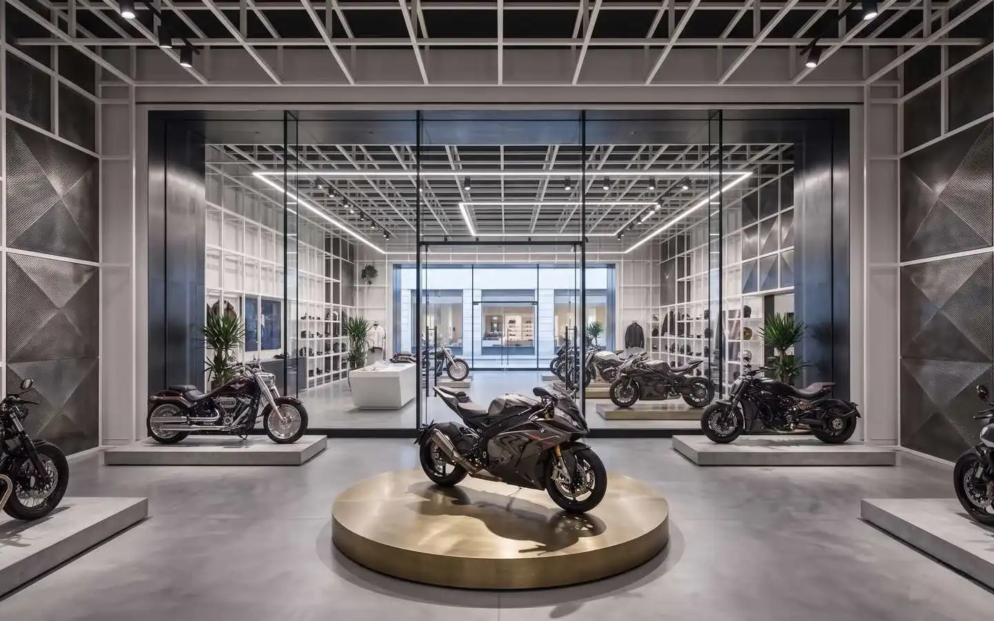 Industrial style motorcycle showroom interior featuring a grid ceiling, glass partitions, and premium motorbikes on circular display pedestals