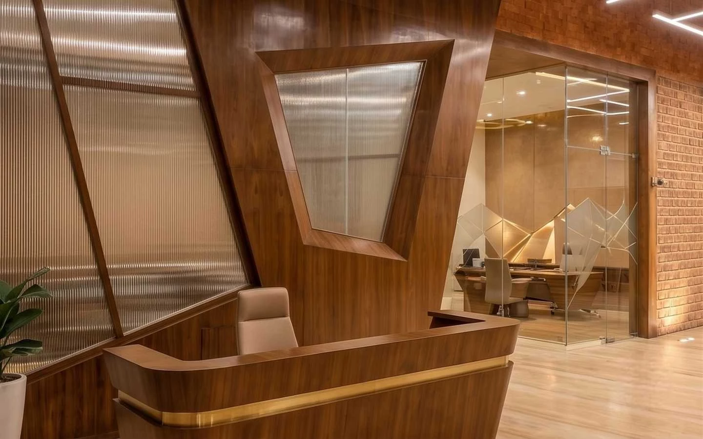 Modern luxury office reception area featuring custom wood wall paneling and fluted glass partitions