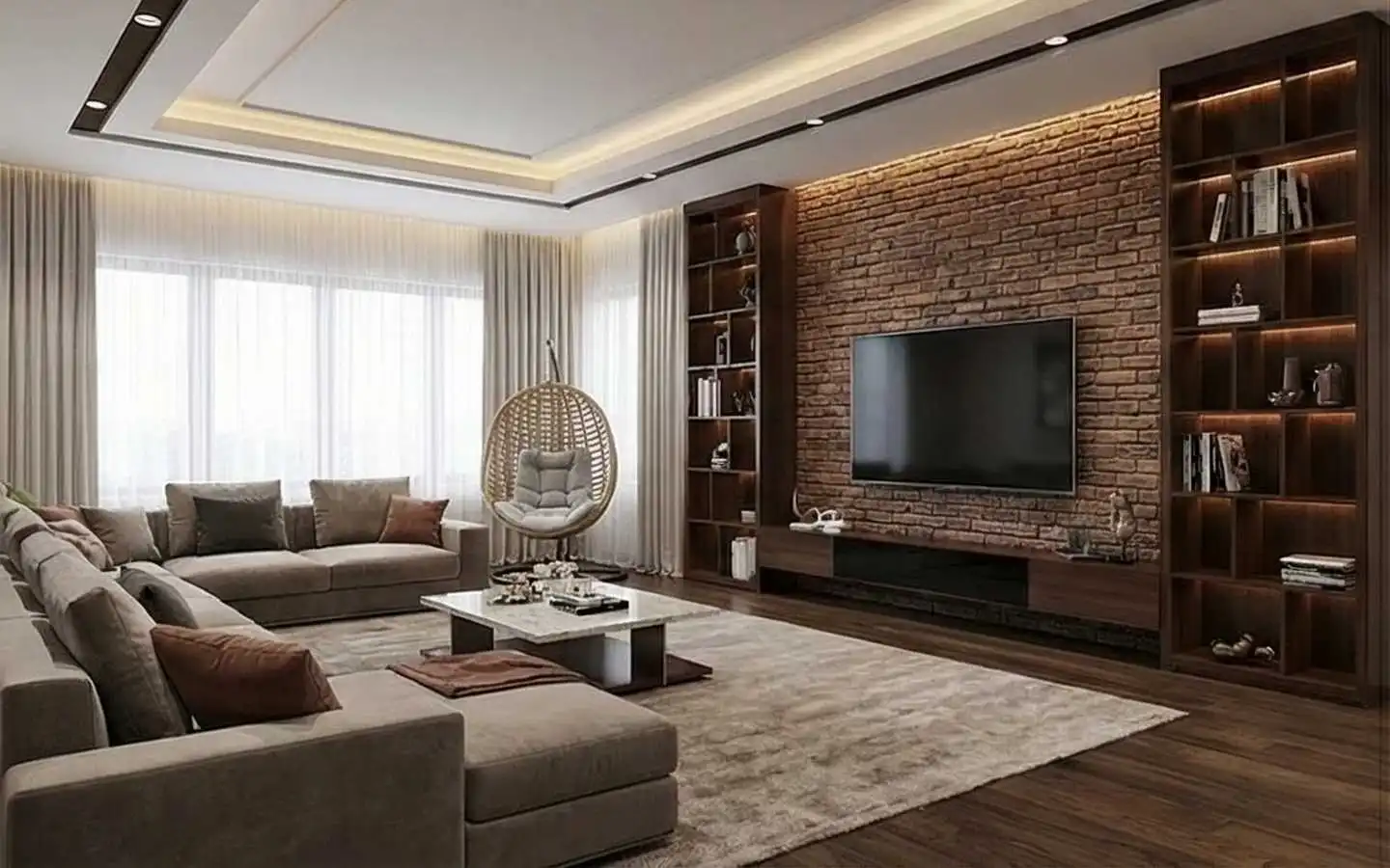 Modern living room featuring a rustic red brick accent wall, a wall-mounted TV between tall dark wood bookshelves, a grey sectional sofa, and a hanging wicker swing chair