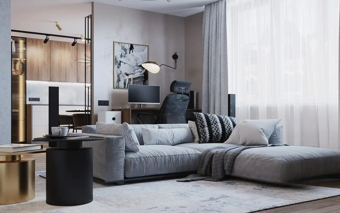 Modern apartment living room featuring a low-profile grey sectional sofa, patterned accent pillows, a minimalist workspace in the background, and industrial track lighting