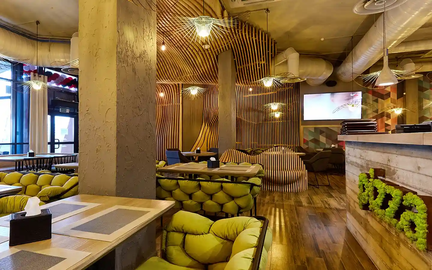 Eco-friendly restaurant interior featuring parametric wood slat wall panels, lime green tufted seating, and unique pendant lighting