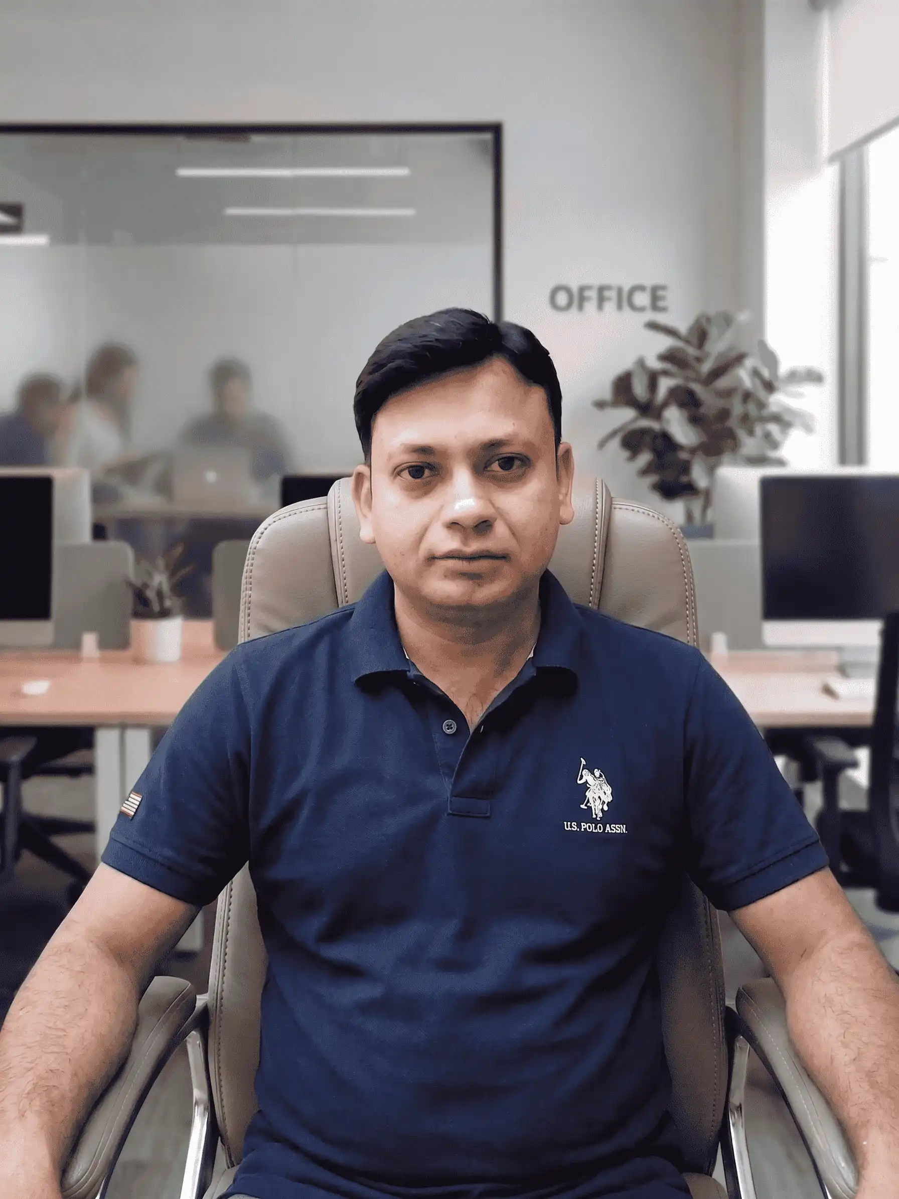 Rashid Ali, founder of 4 Lotus Interior, seated in a modern office environment for his company vision profile
